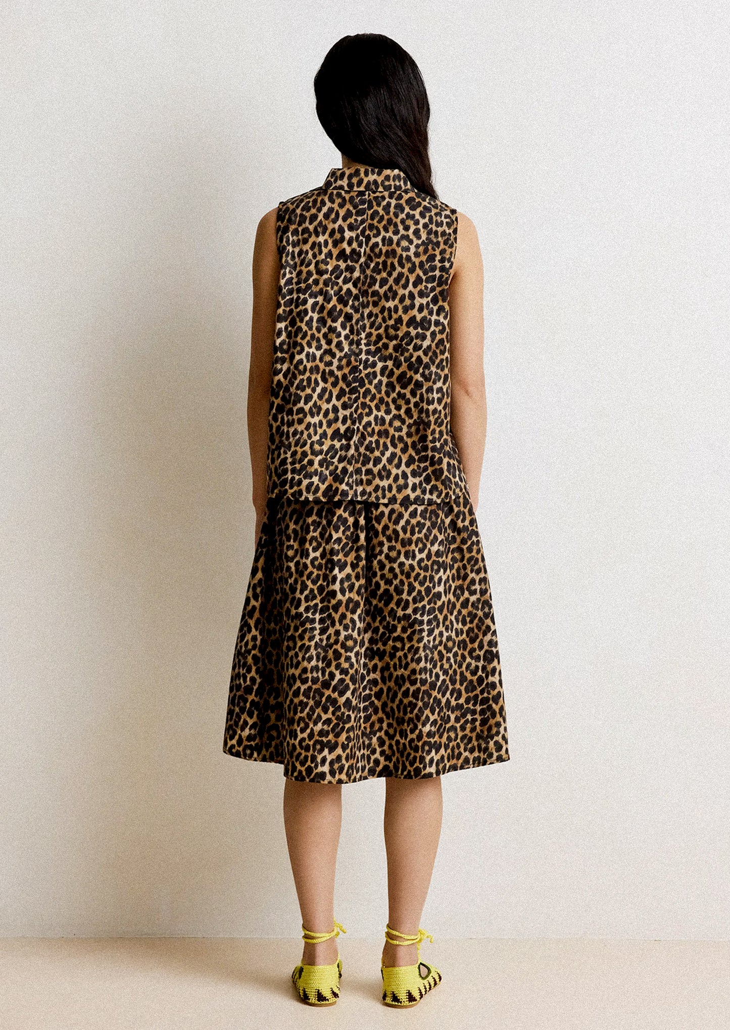 Leopard print skirt worn by a person on a plain background