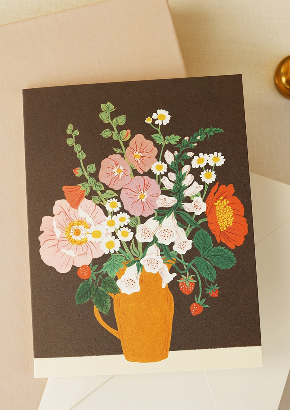 A greeting card with floral arrangement on brown background.