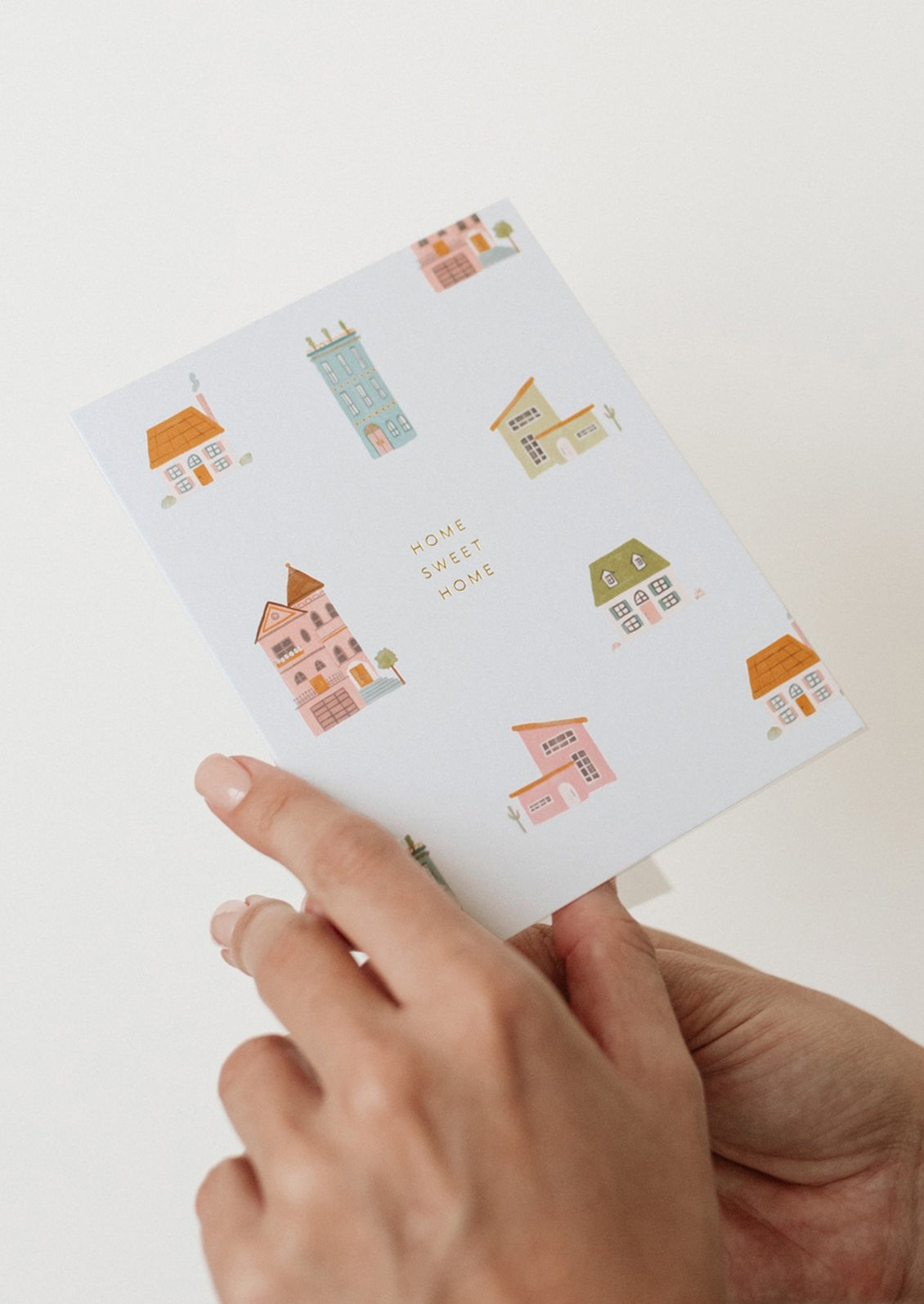 A greeting card with houses print reading "home Sweet Home".