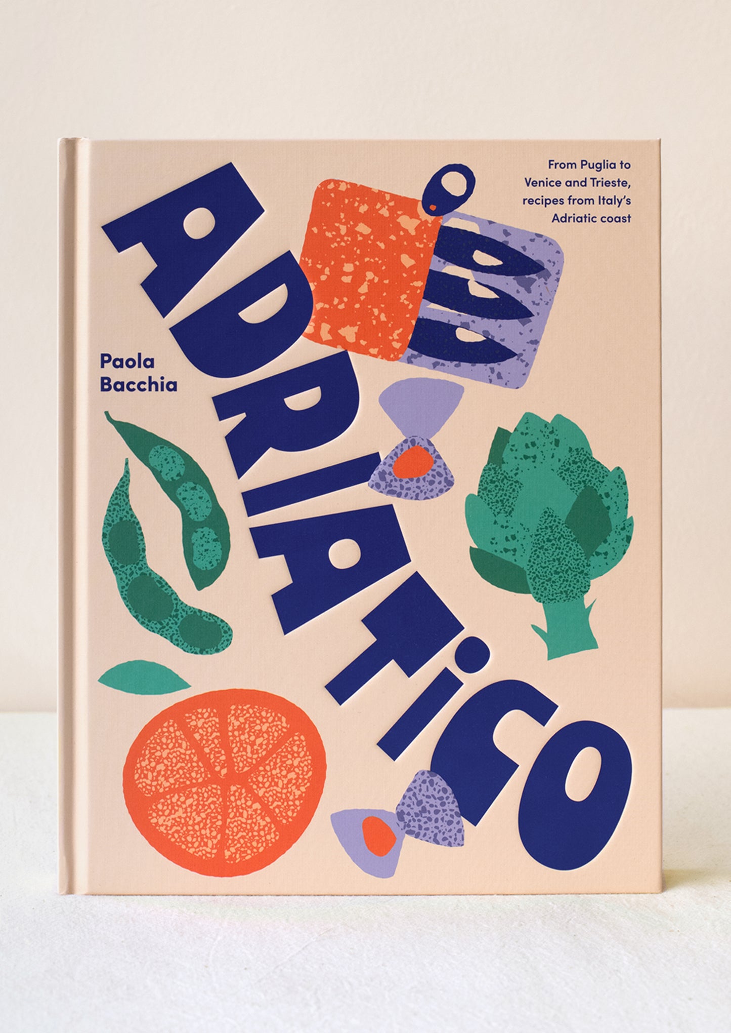 A cookbook with artichoke, pasta and sardine tin illustrations on cover.