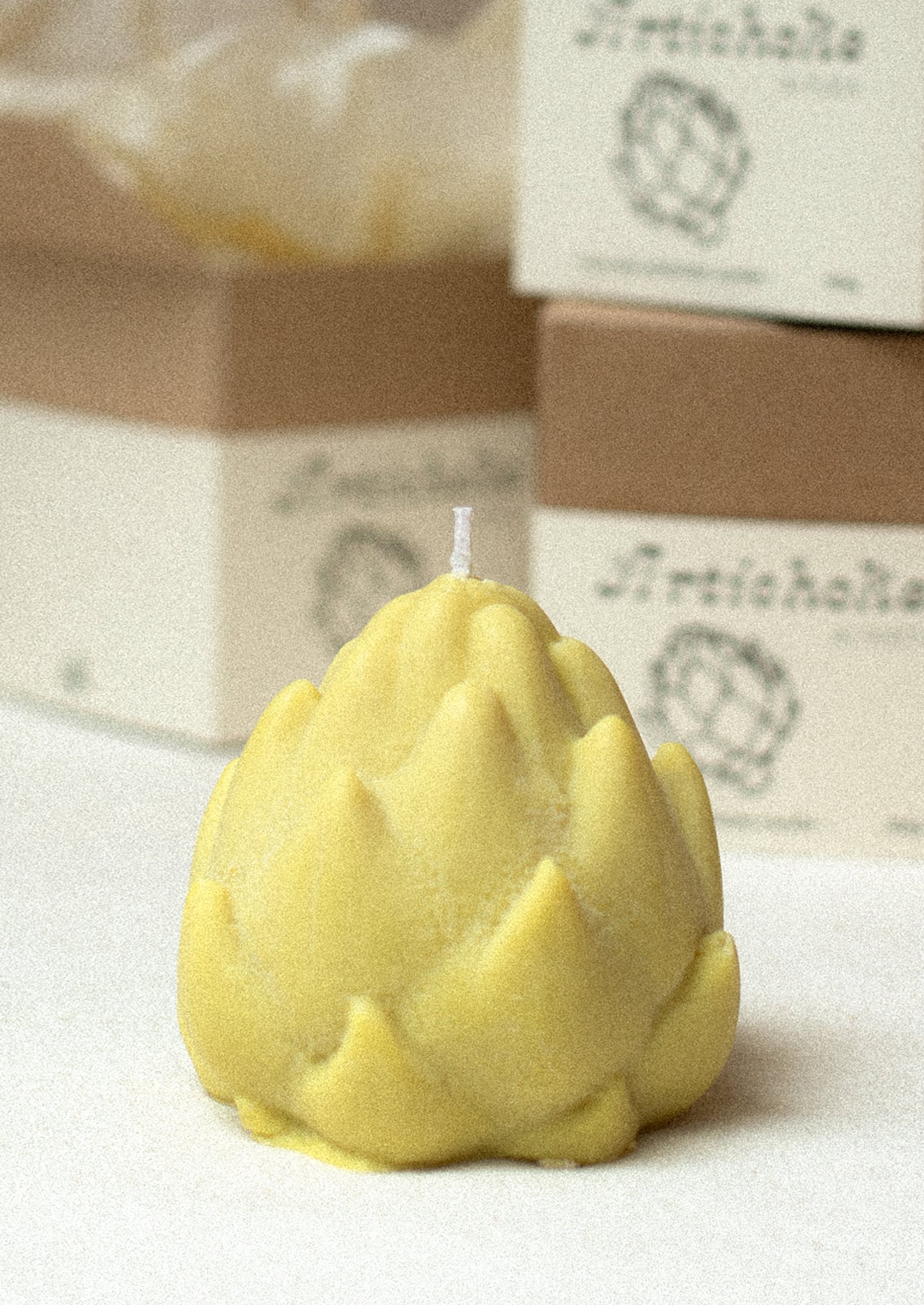 A custom shaped candle in realistic shape of artichoke.