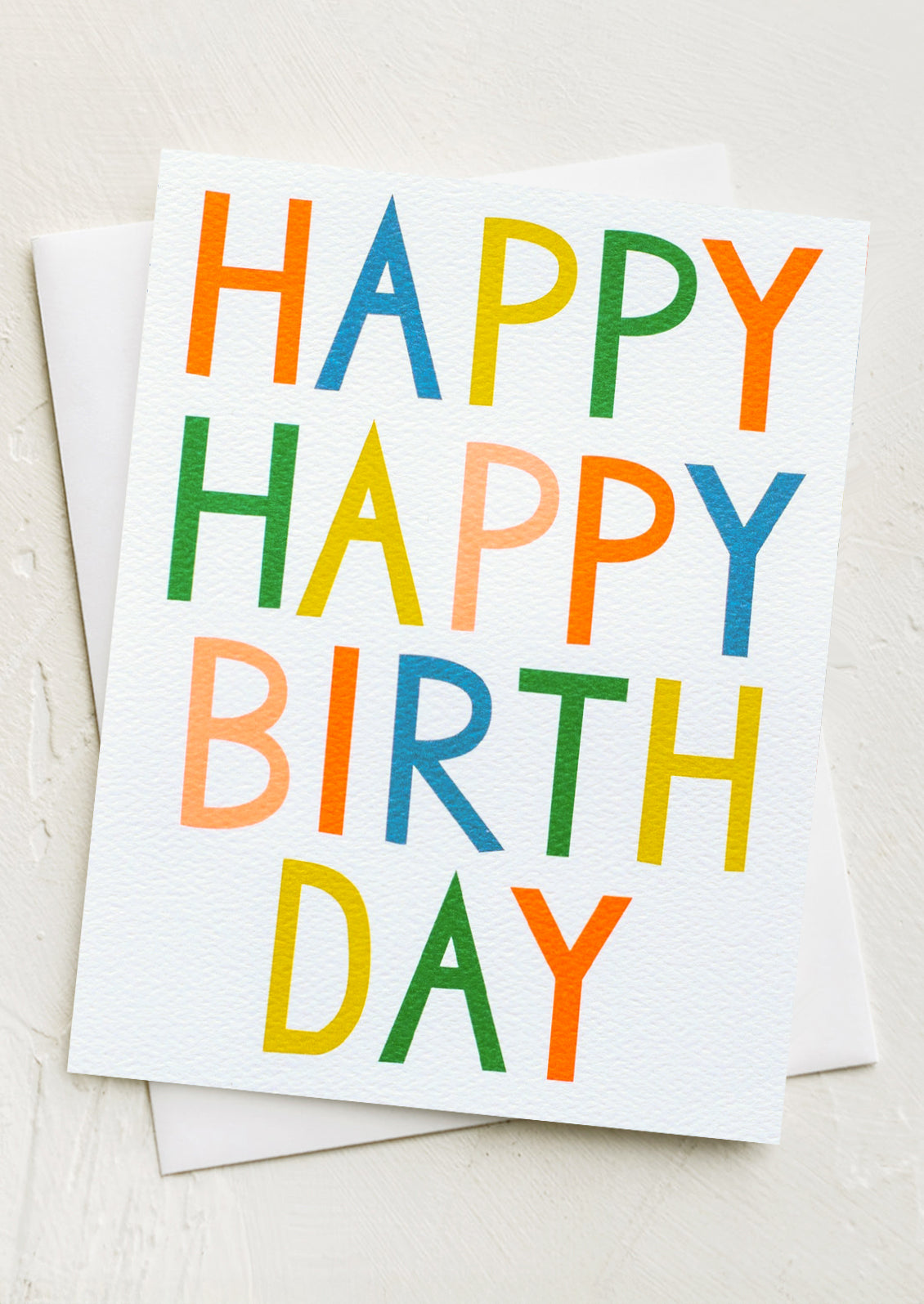 A card with colorful letters reading "Happy happy birthday".