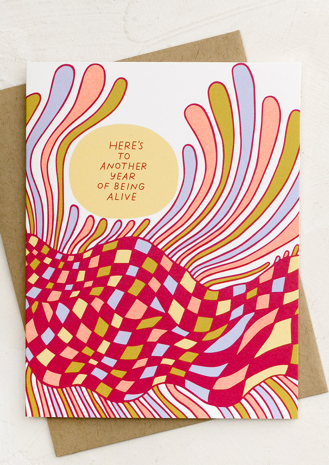 A greeting card reading "here's to another year of being alive".