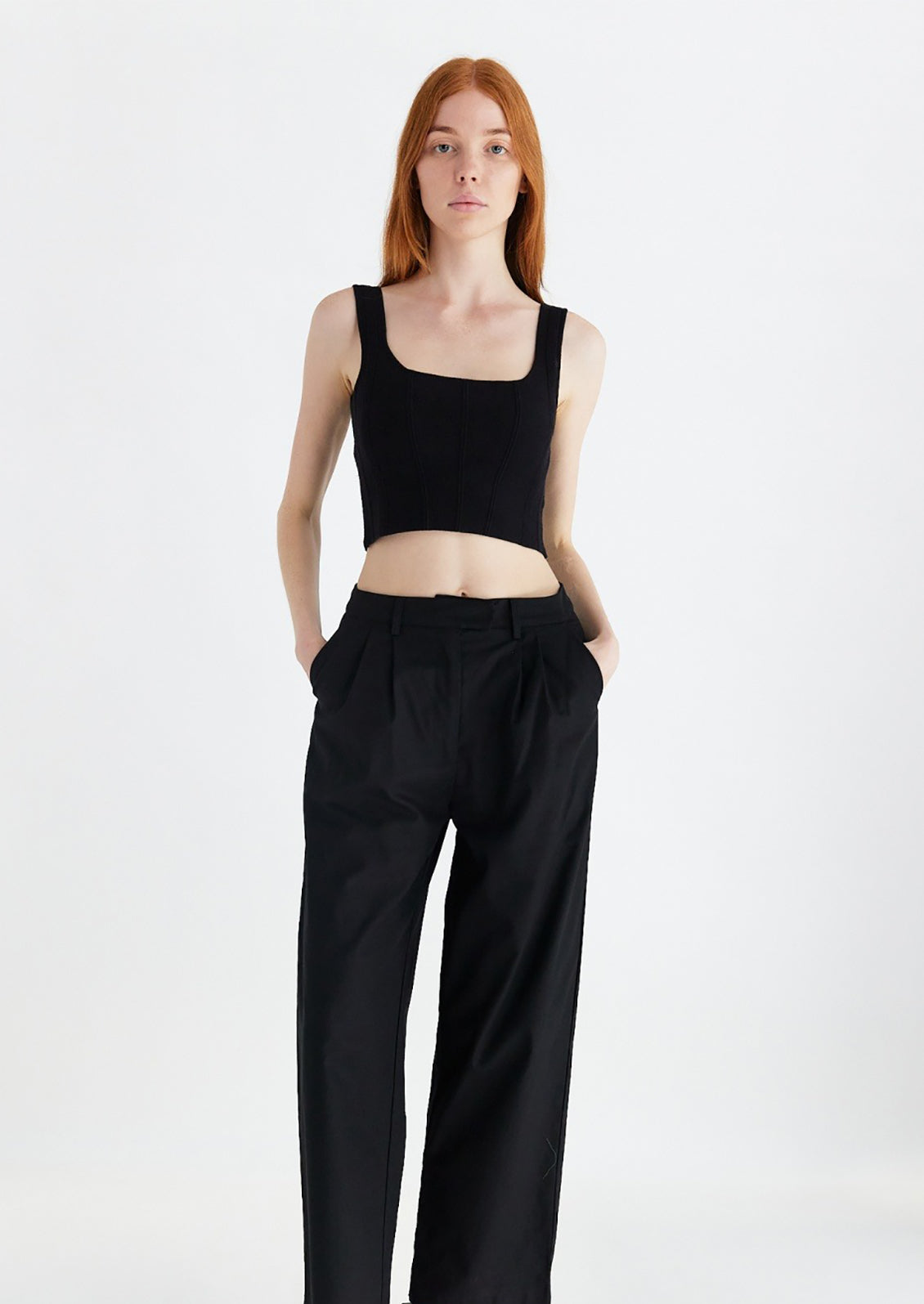 Woman wearing black knit cropped tank.