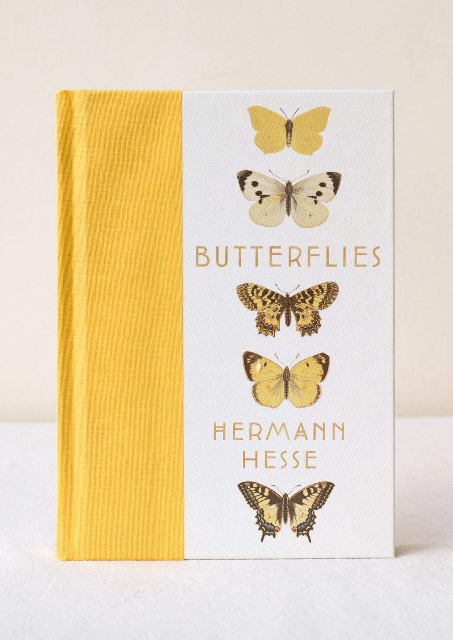 A hardcover book titled "Butterflies" with yellow cloth bound spine.