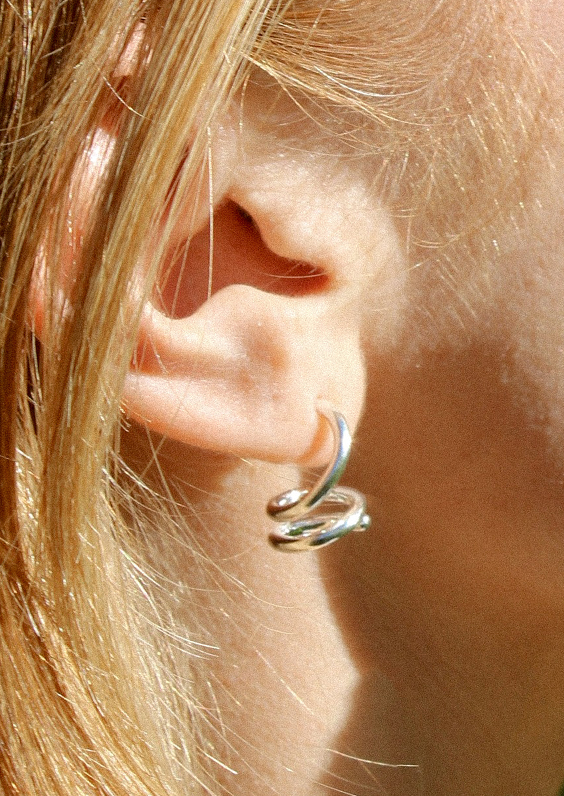 A pair of sterling silver earrings in coil shape.