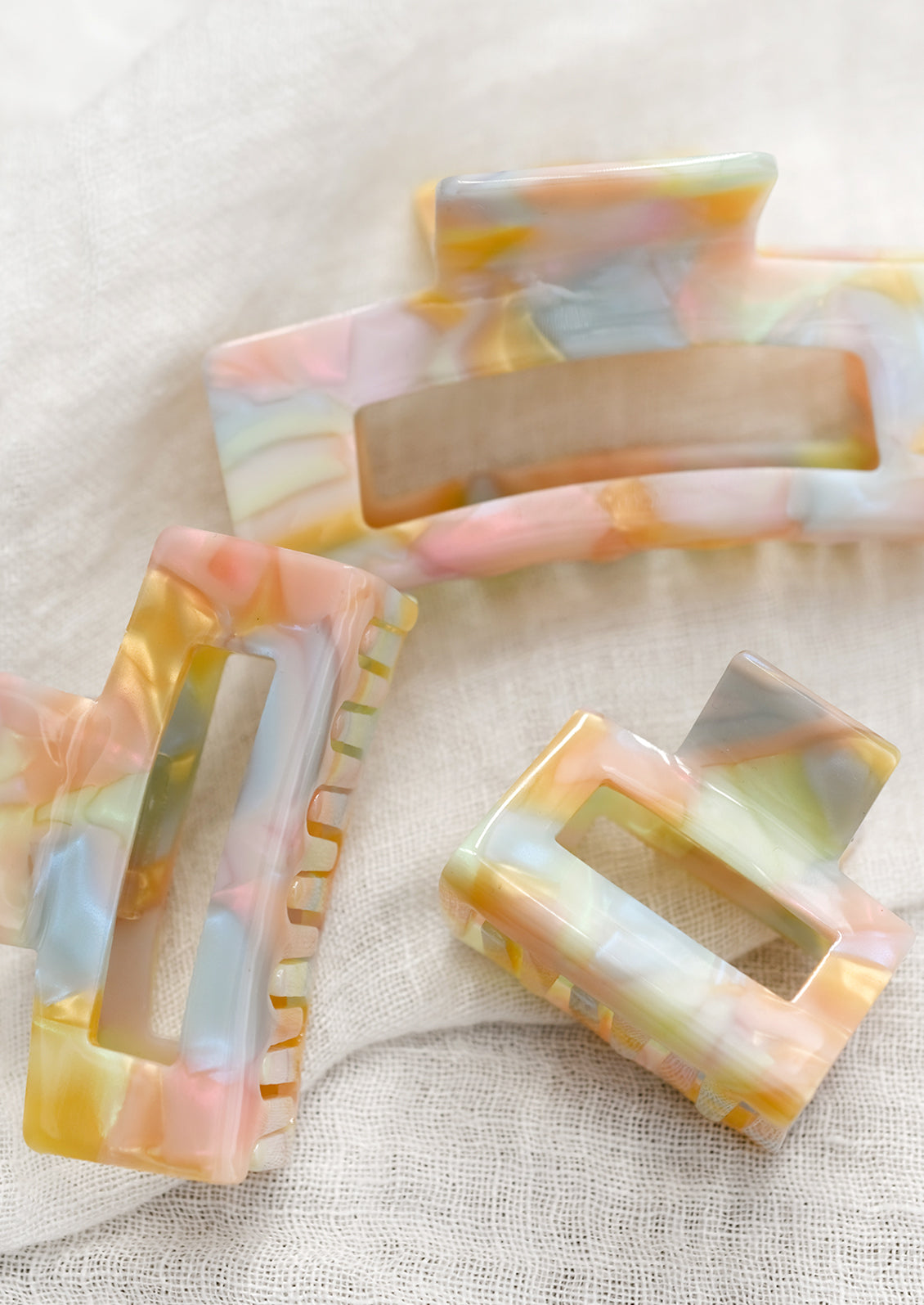 Hair claws in pastel, prismatic colors.