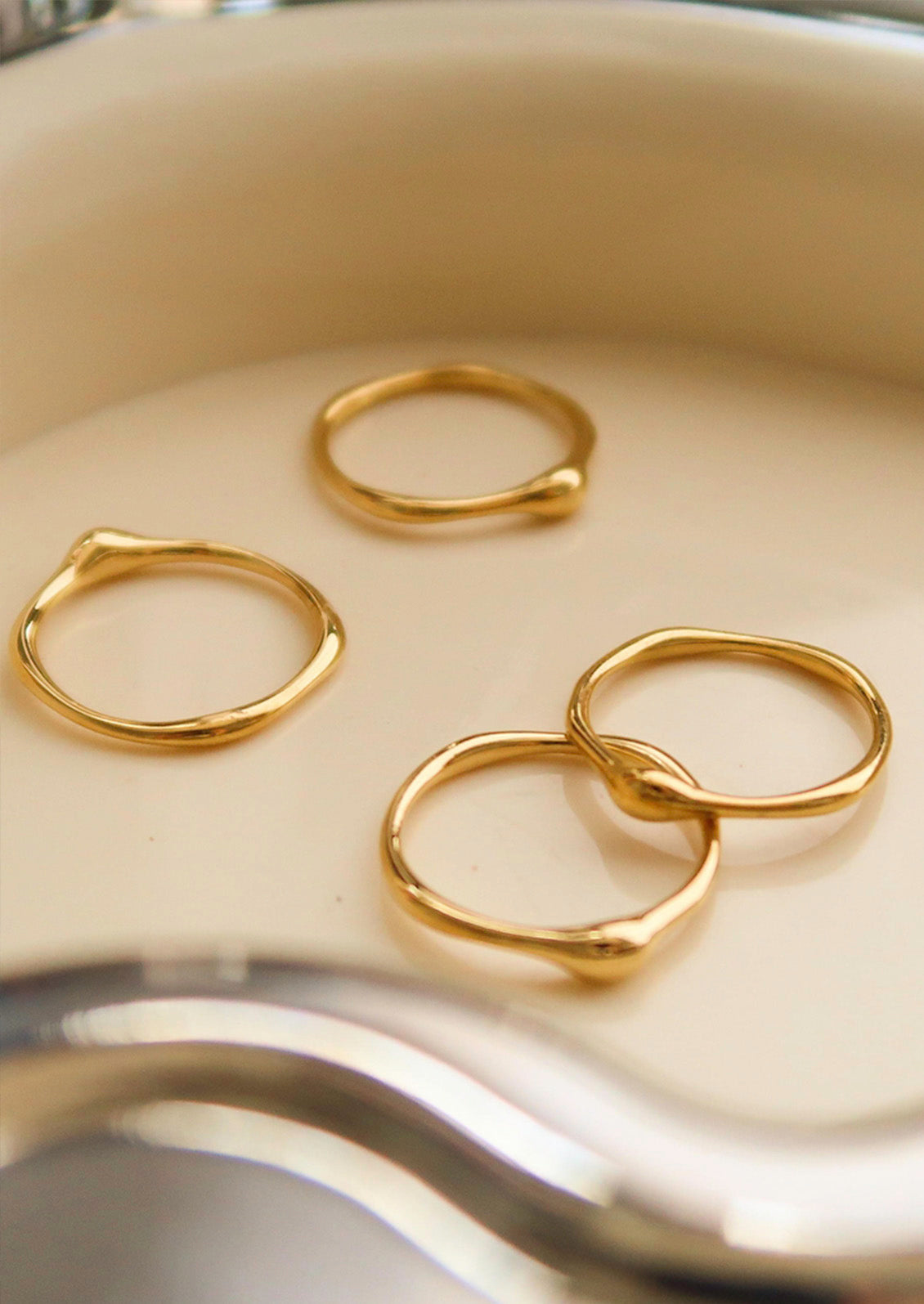 Gold rings on a white surface