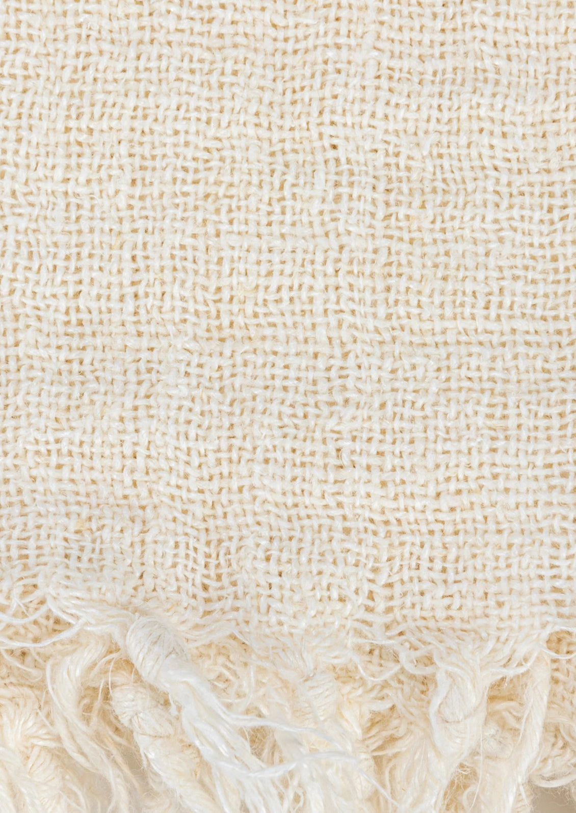An ivory linen throw with a mix of different weave gauges.