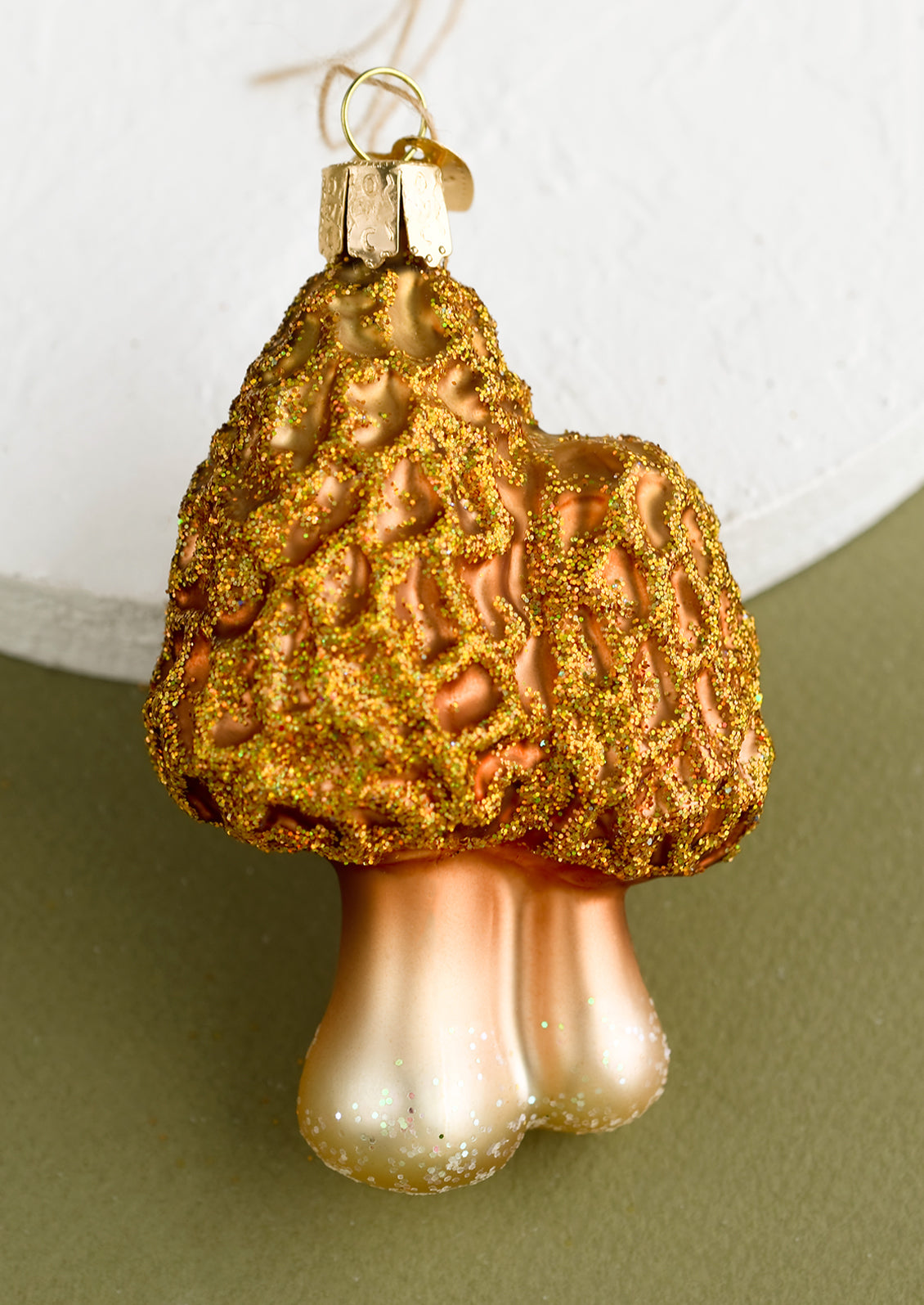 A glass holiday ornament of morels mushrooms.