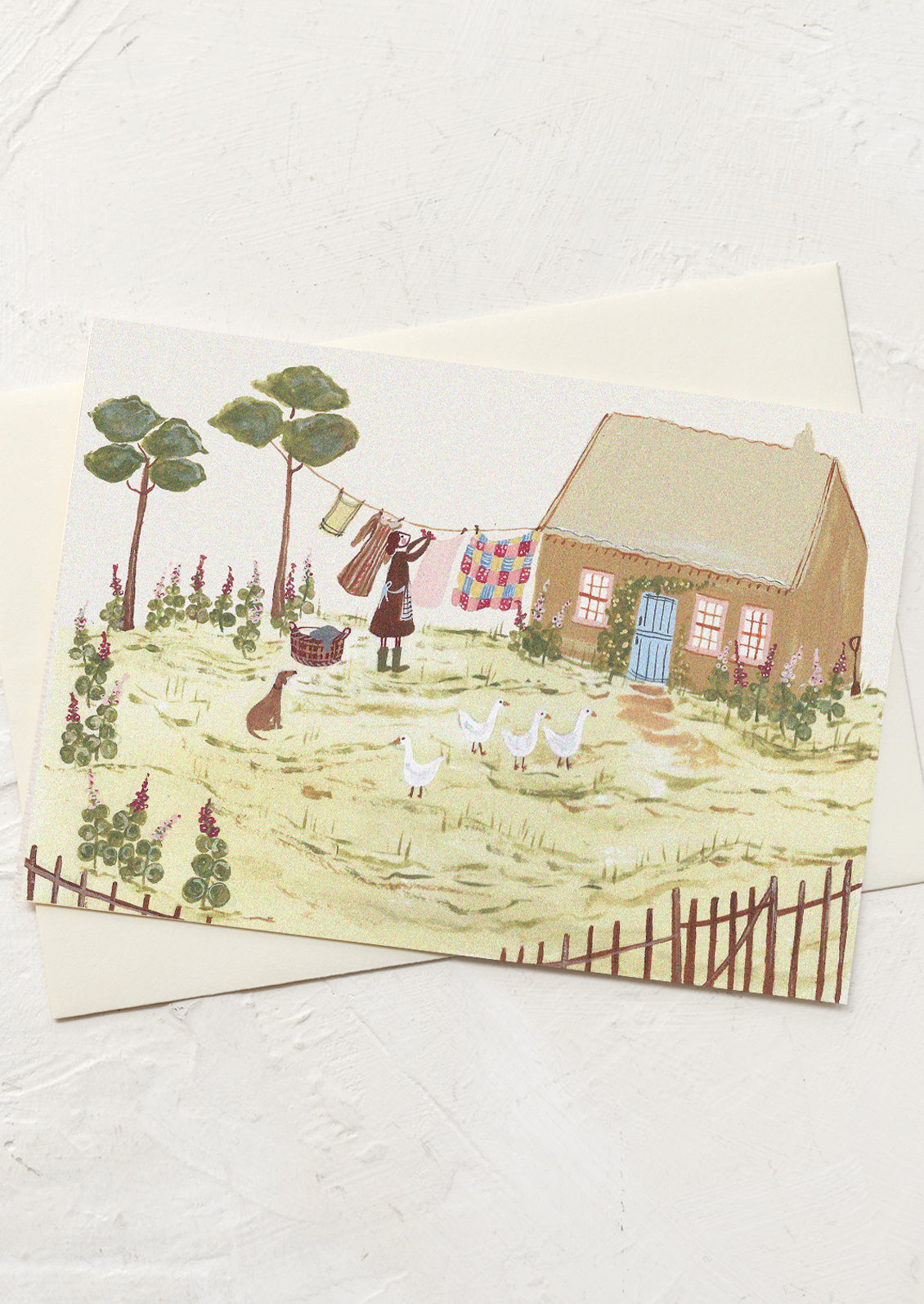 A greeting card with illustration of cottage scene with person, dog and geese.