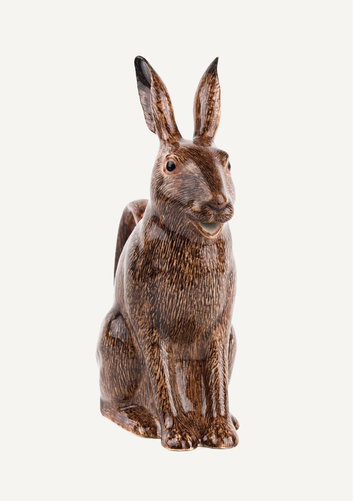 A brown ceramic pitcher in the realistic shape of a rabbit, water pours from rabbit's mouth.