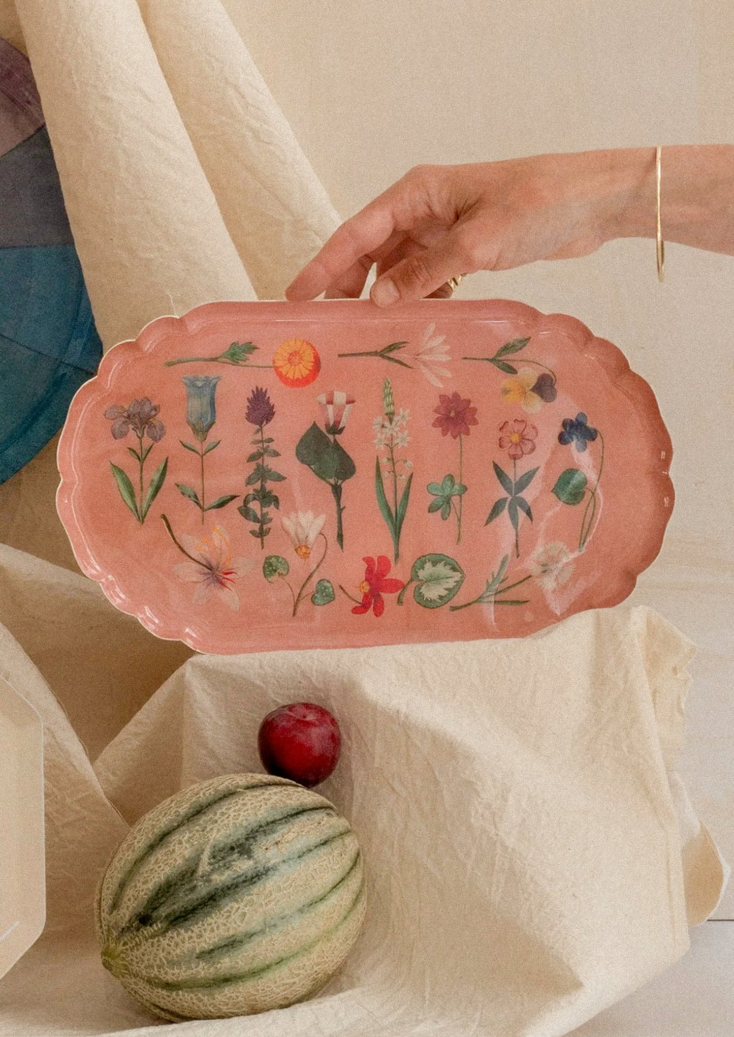 Pink decorative tray with floral patterns.