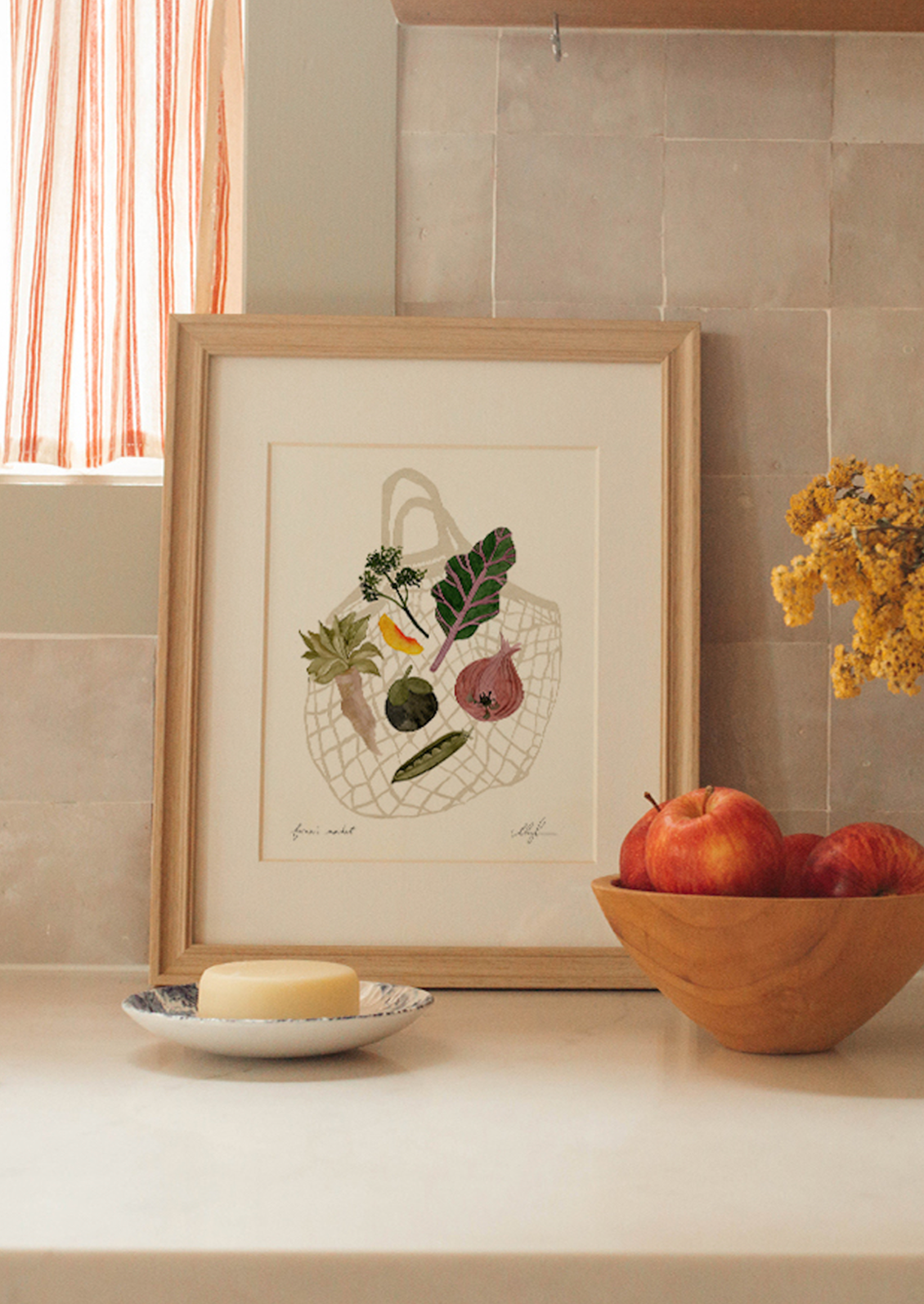 An art print of an illustration of a net bag with fruits and vegetables.