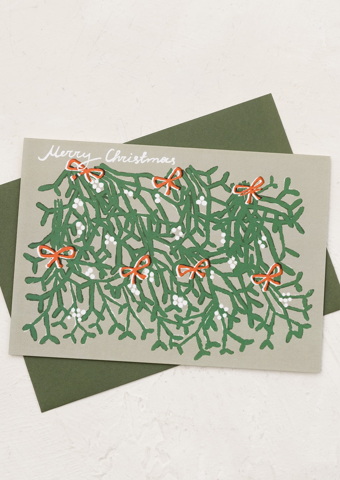 An illustrated card with mistletoe graphic and text reads "Merry Christmas".