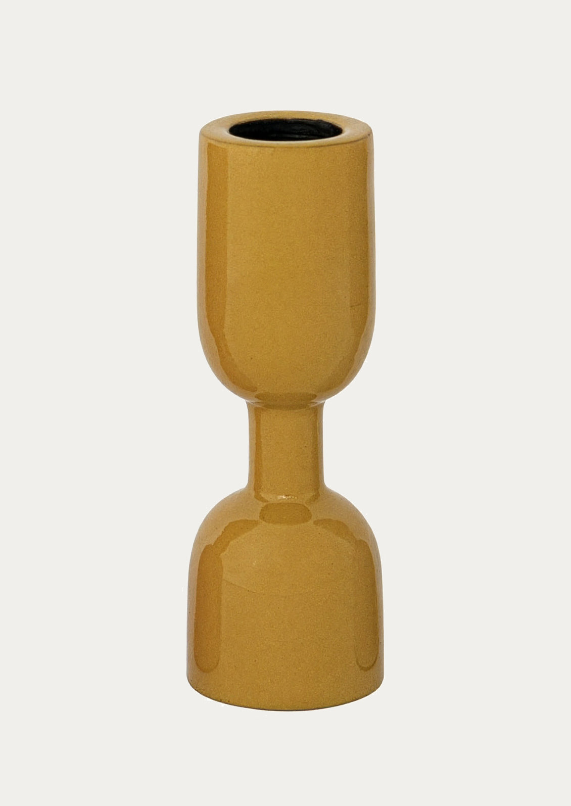 An enamel candle holder in mustard.