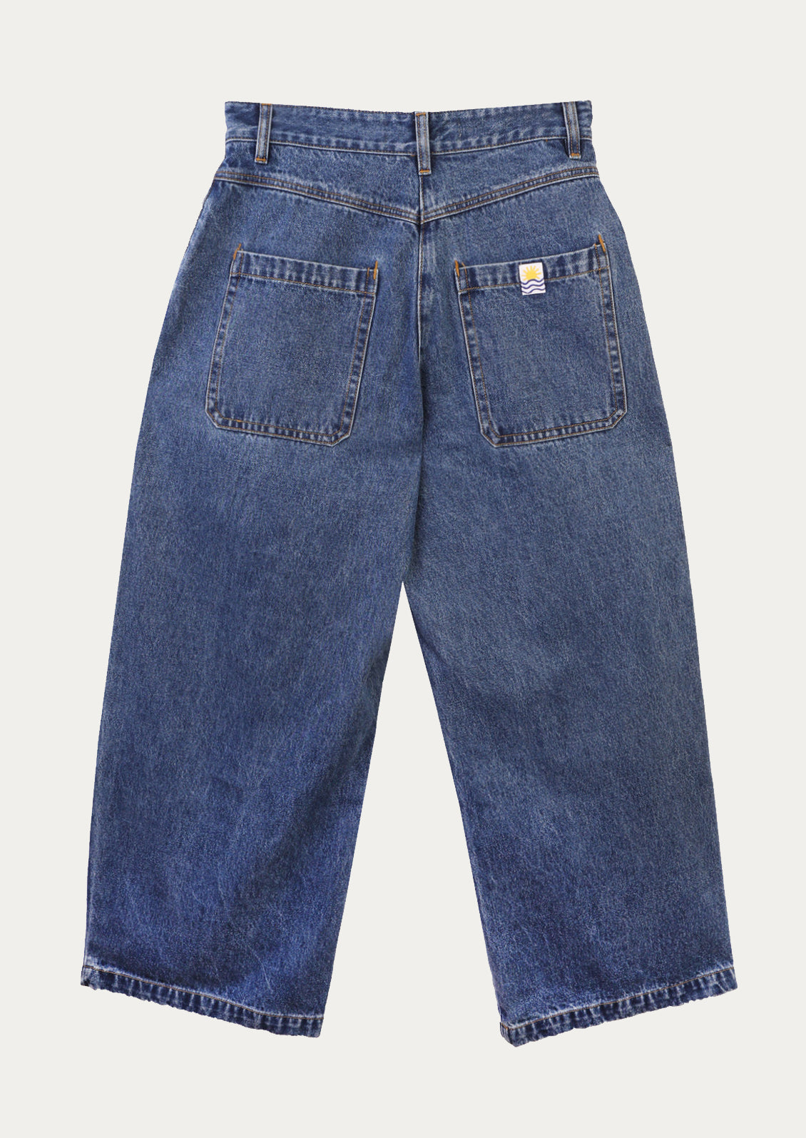 A pair of baggy pleat front jeans in medium blue wash.