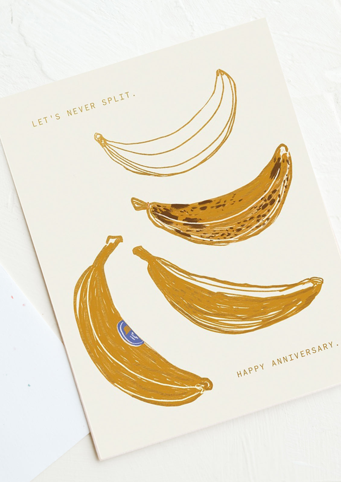 A card with illustration of bananas, text reads "Let's Never Split. Happy Anniversary".