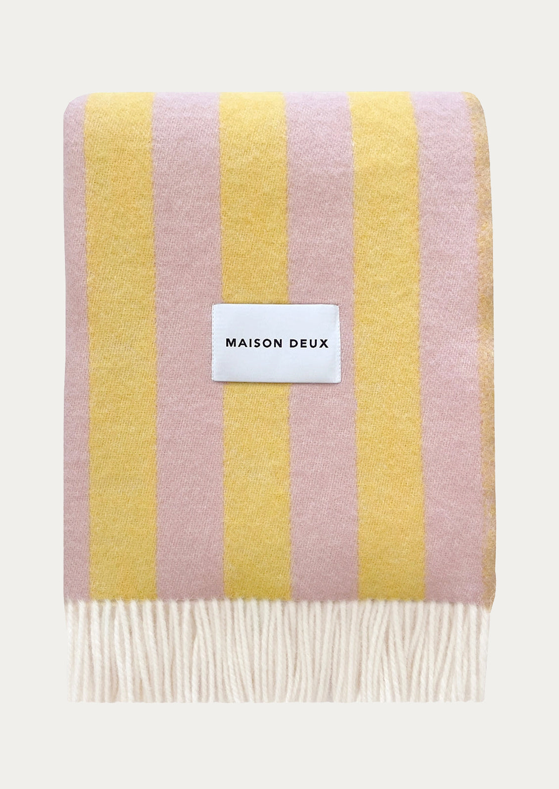 A striped wool blanket in pink and yellow.
