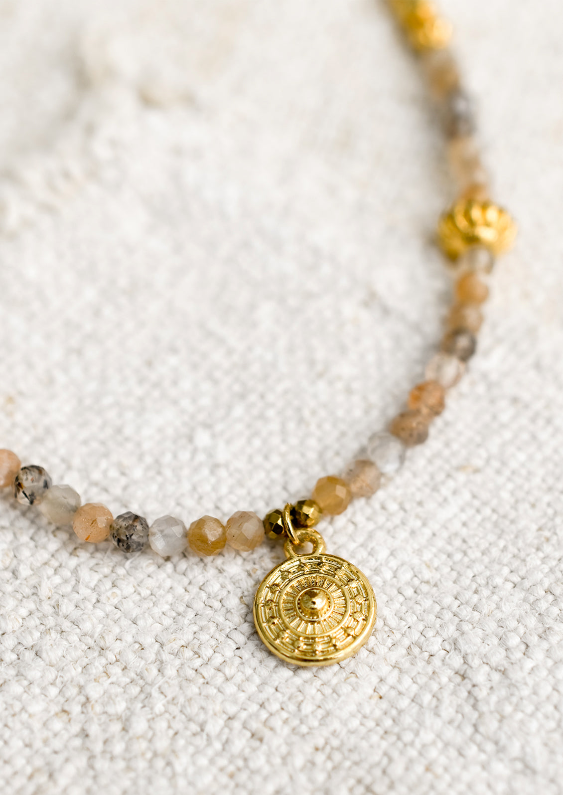 A beaded orange moonstone necklace with gold findings.