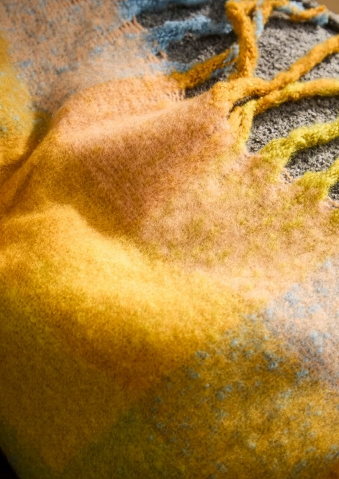 Close-up of a textured fabric with yellow and gray colors