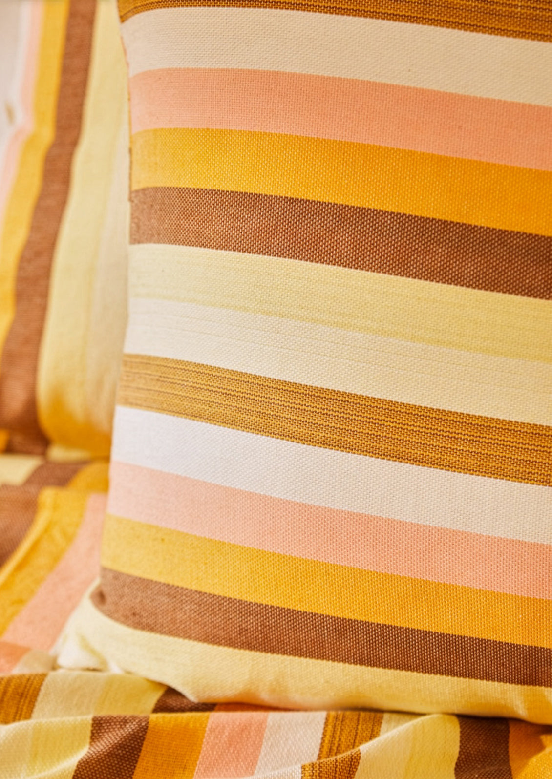 Close-up of striped fabric with warm colors on a blurred background