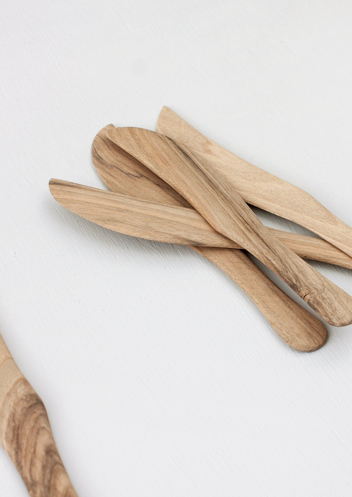 Assorted walnut wood cheese knives.