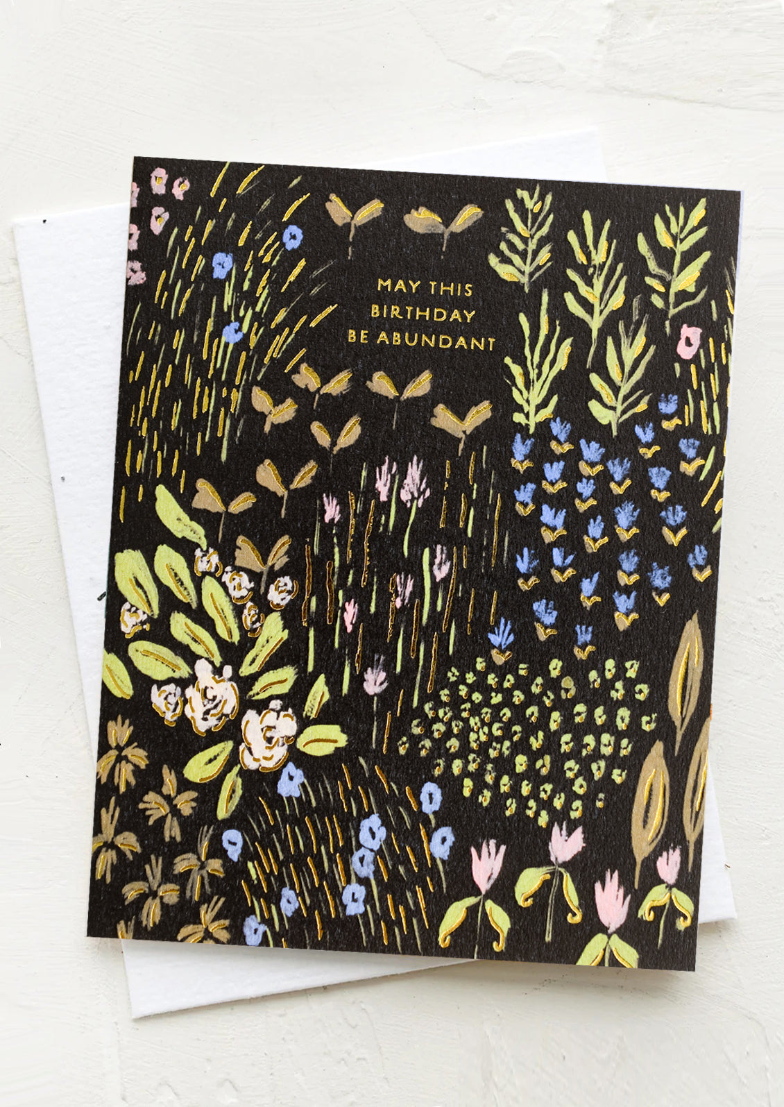 A black background floral print card reading "May this birthday be abundant".