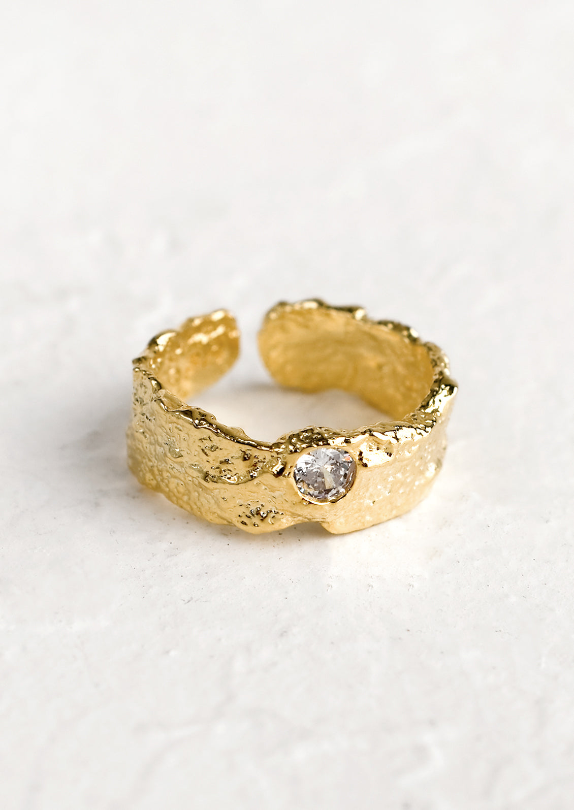 A chunky organically textured ring with single crystal detail.