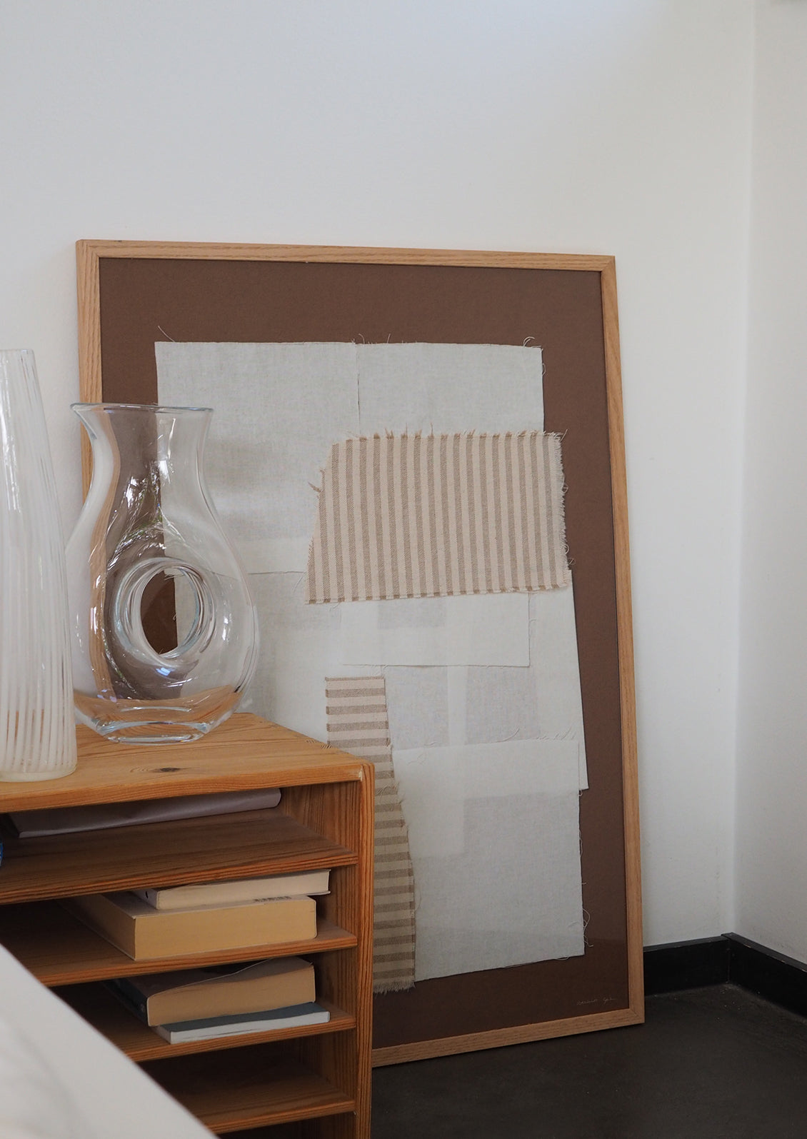 A brown art print with photographed textiles in ivory and tan stripes.