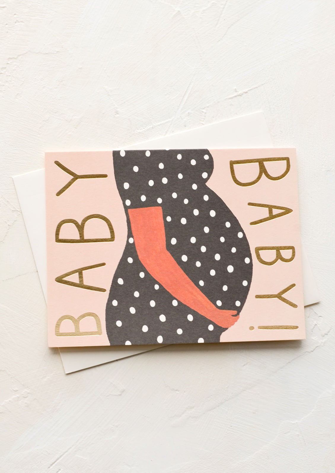 A card featuring woman's pregnant stomach with gold lettering on sides reading "BABY".
