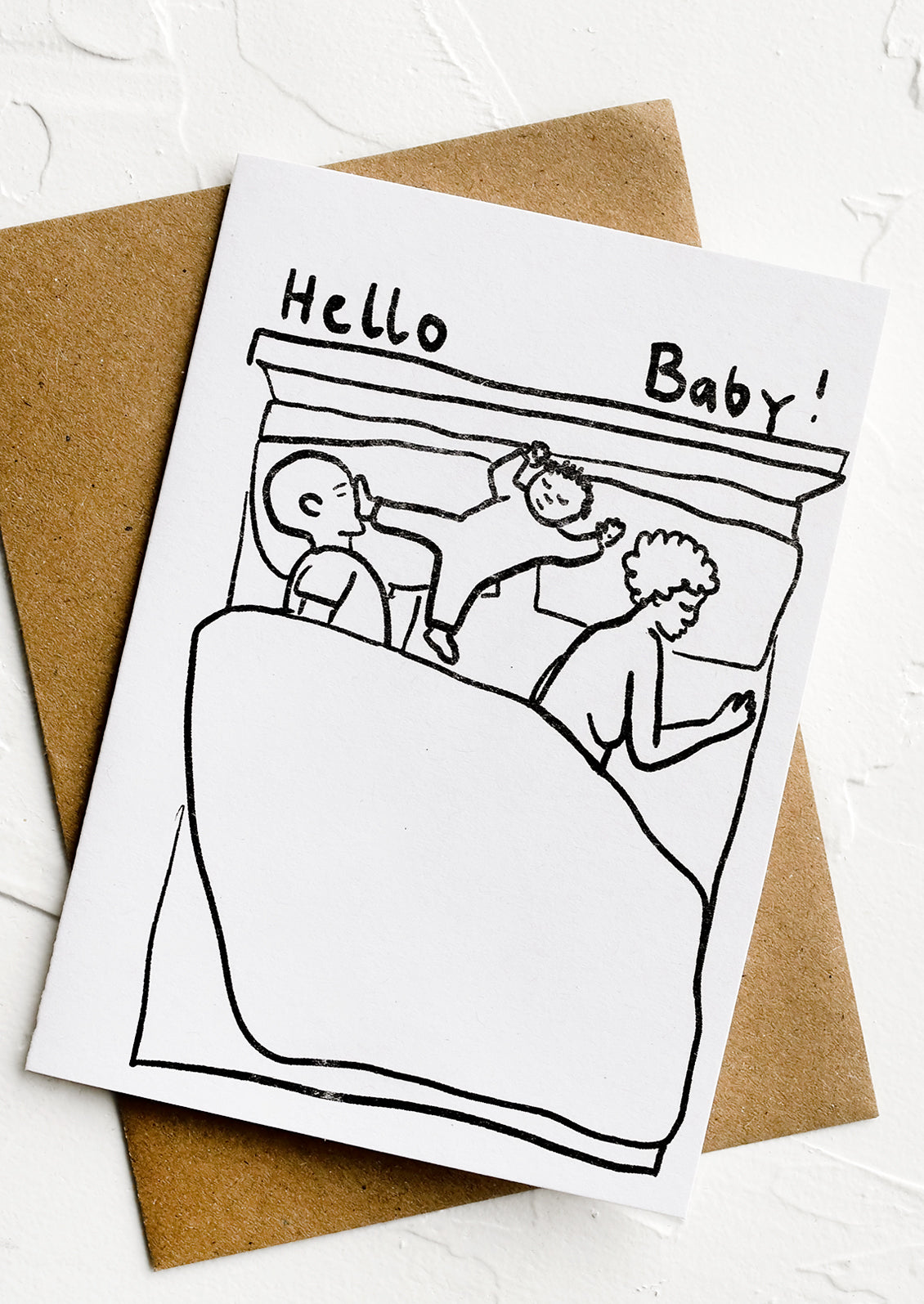A black and white greeting card with illustration of baby in a bed.