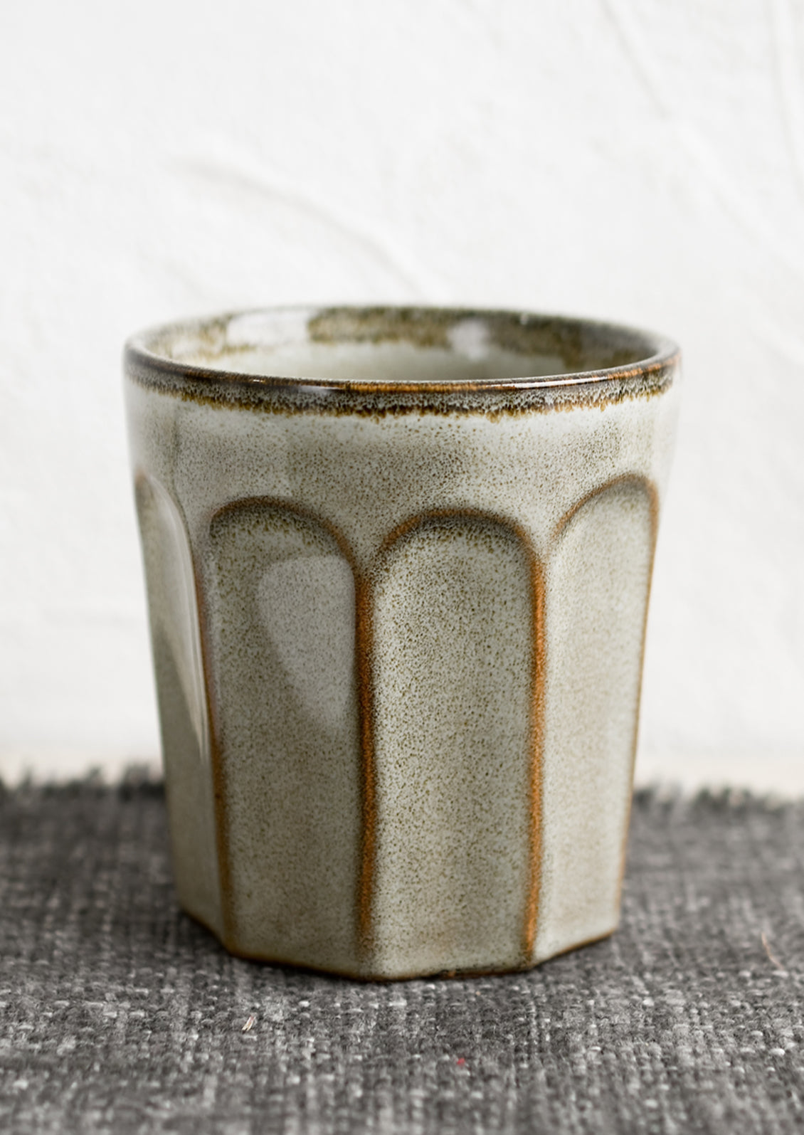 A ceramic bistrot style cup in pebble (brownish-grey).