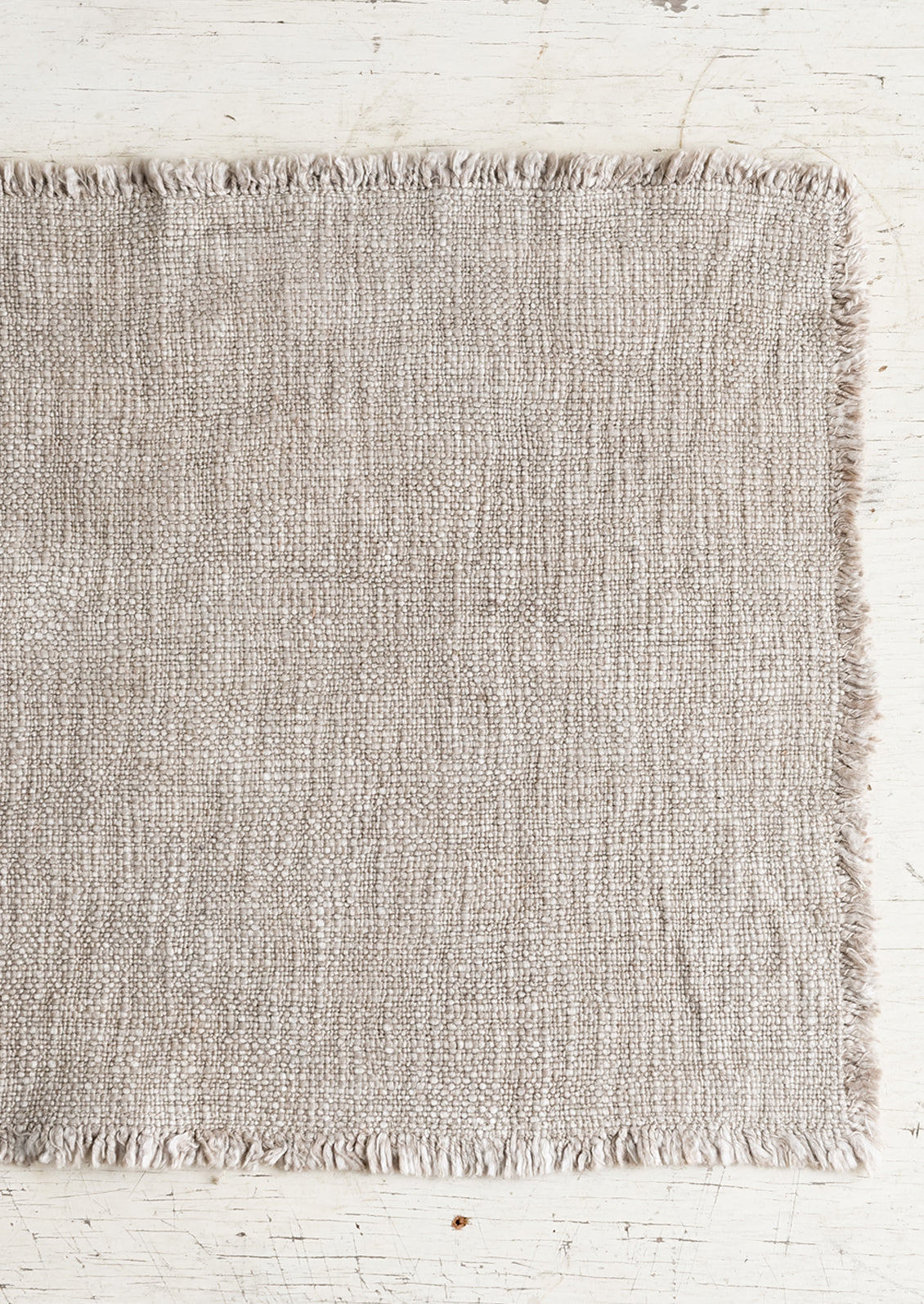 A slub boucle textured placemat in taupe.