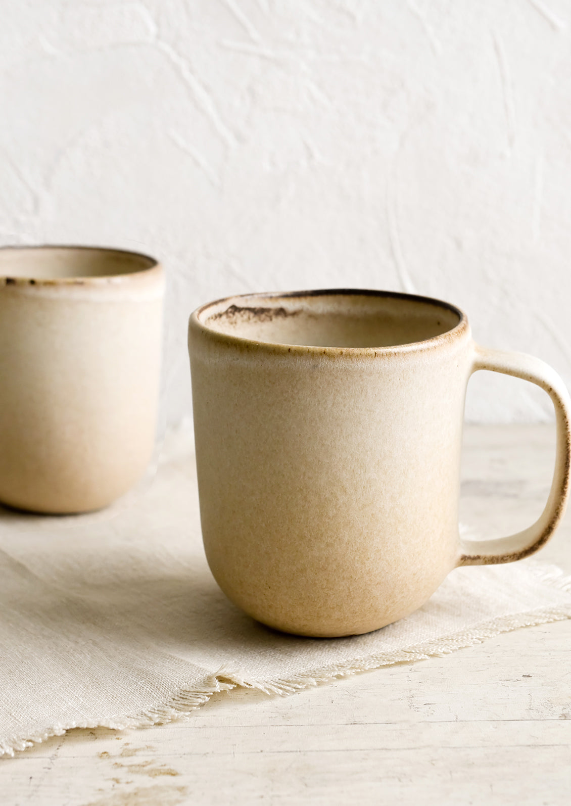 Matte tan ceramic coffee mugs.