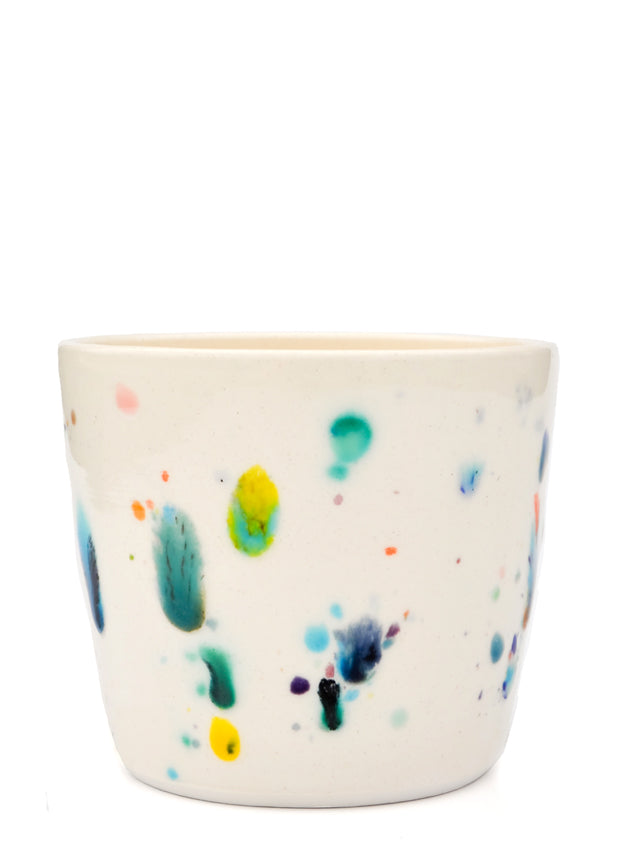 Short ceramic cup with colorful glaze drips