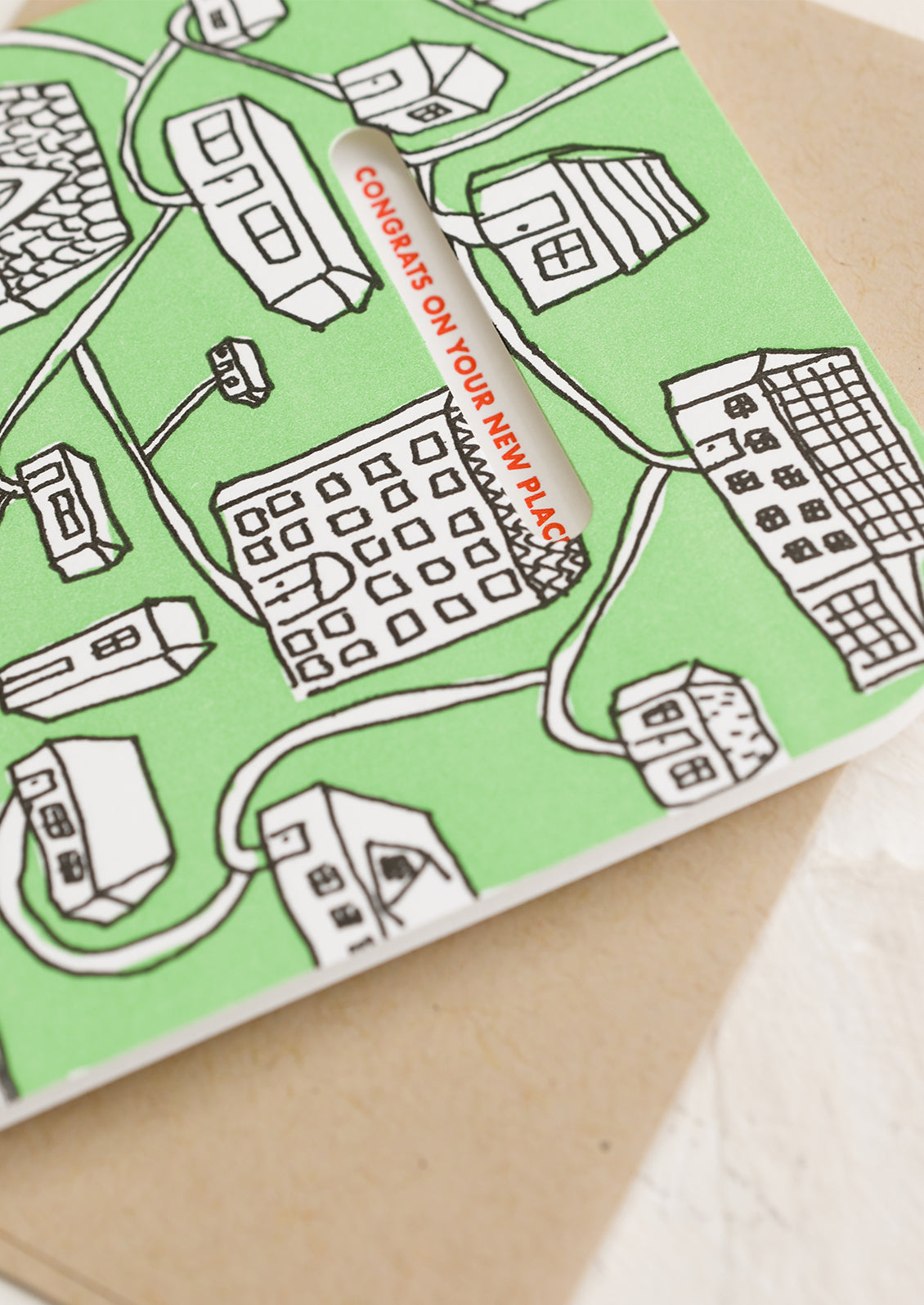 A green card with images of houses.
