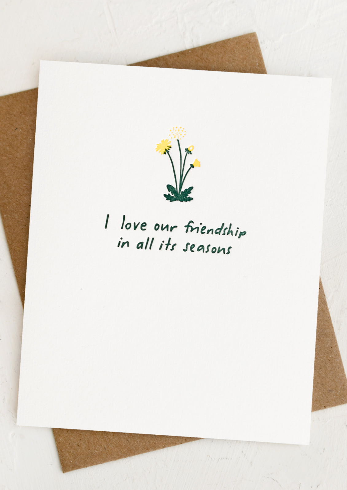 A card with tiny dandelion image, text reads "I love our friendship in all its seasons".