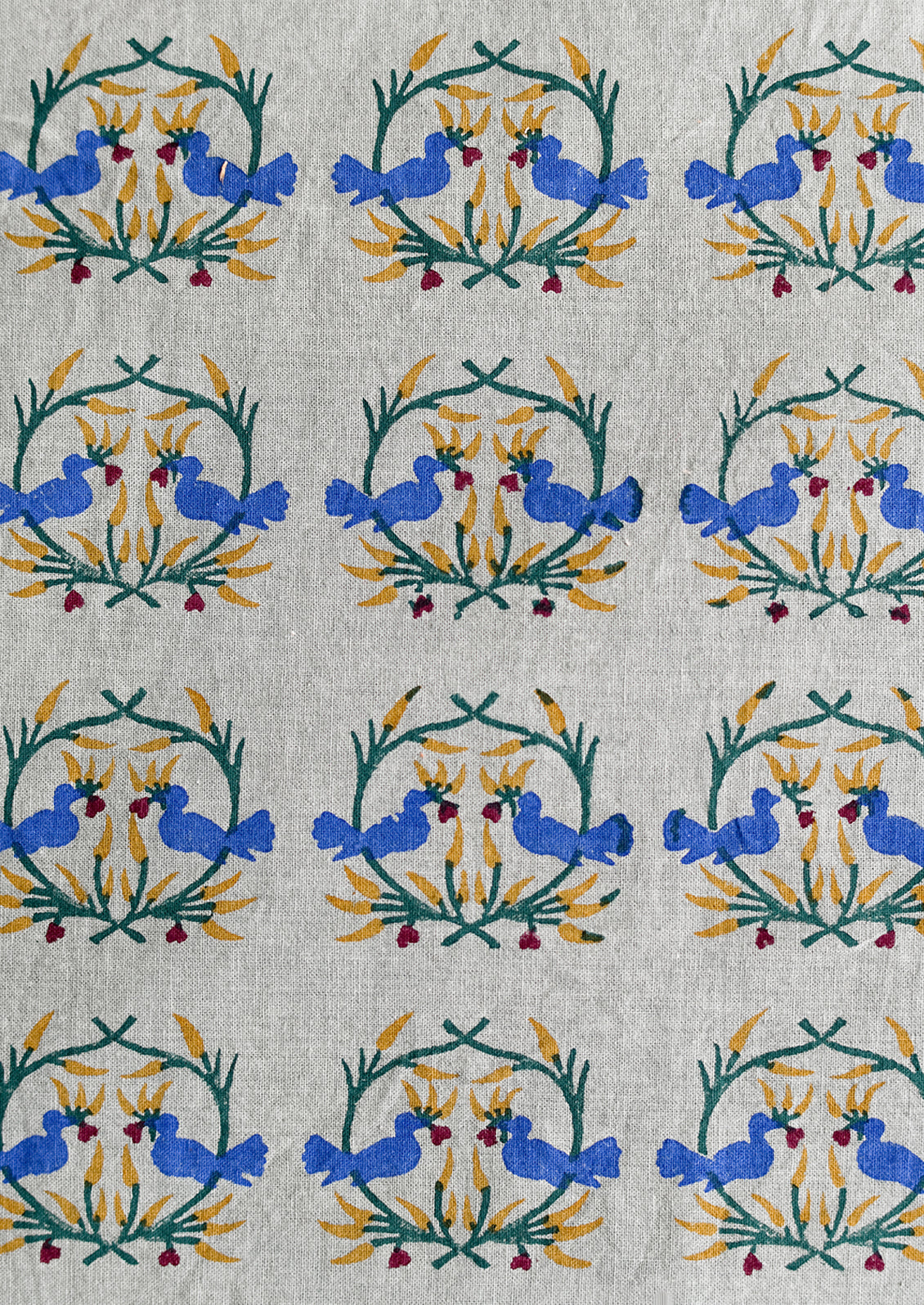 A placemat with block print of kissing birds.
