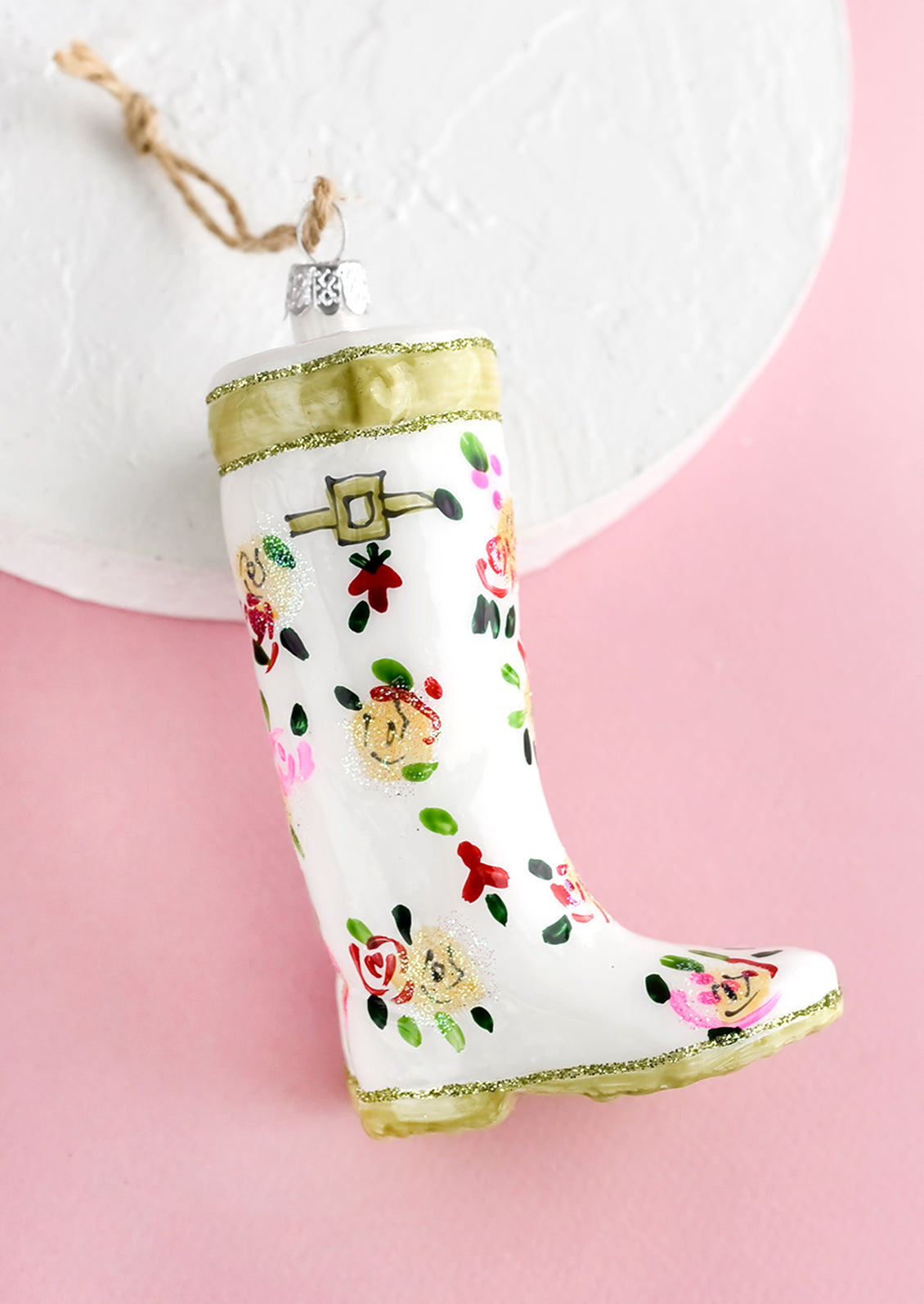 A decorative glass ornament in the shape of floral print garden wellies.