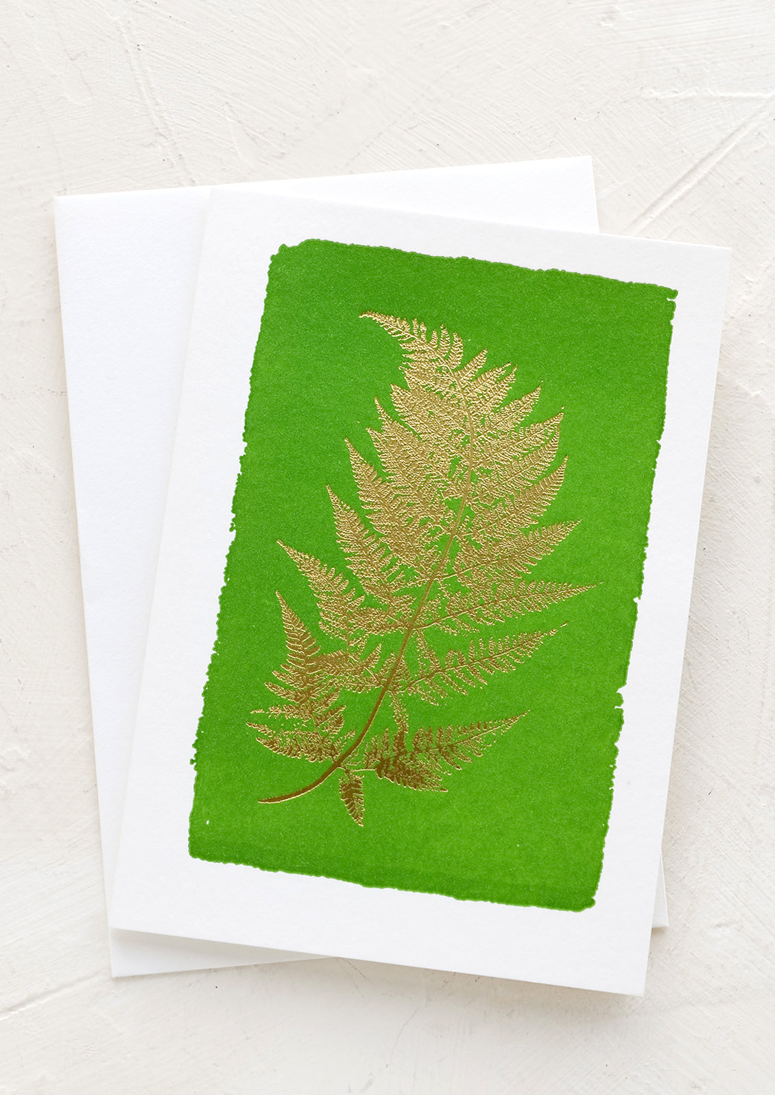 A card with green watercolor background and gold fern image.