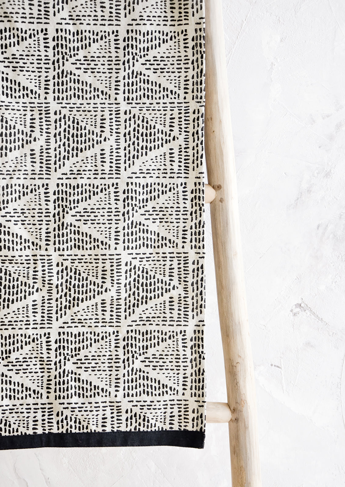 Table runner in natural cotton with black border and geometric print in black