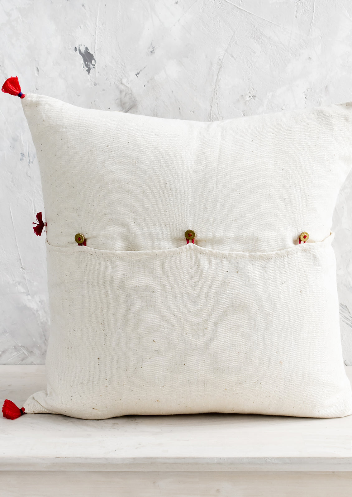 A button back closure on a throw pillow.