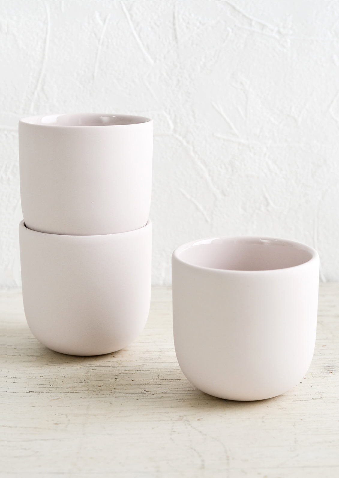 Three pale lavender matte porcelain short tumblers.