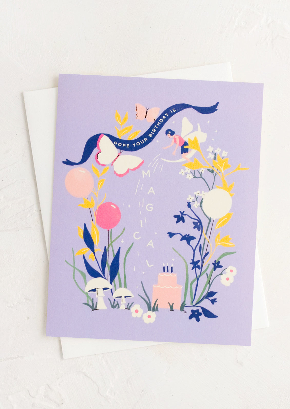 A purple greeting card with image of fairies and cake reading "Hope your birthday is magical".