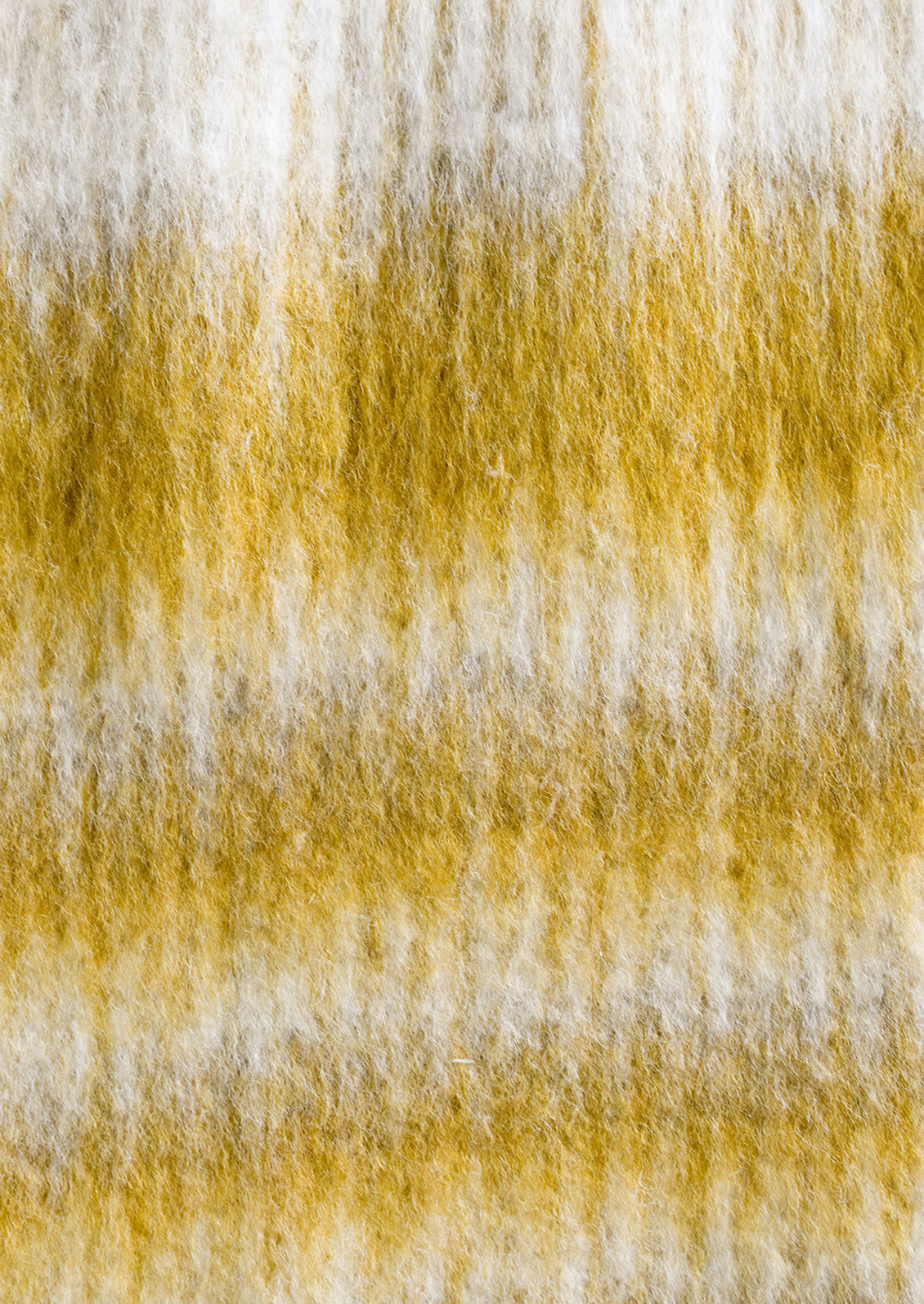 A mohair throw blanket in mustard and ivory stripe.