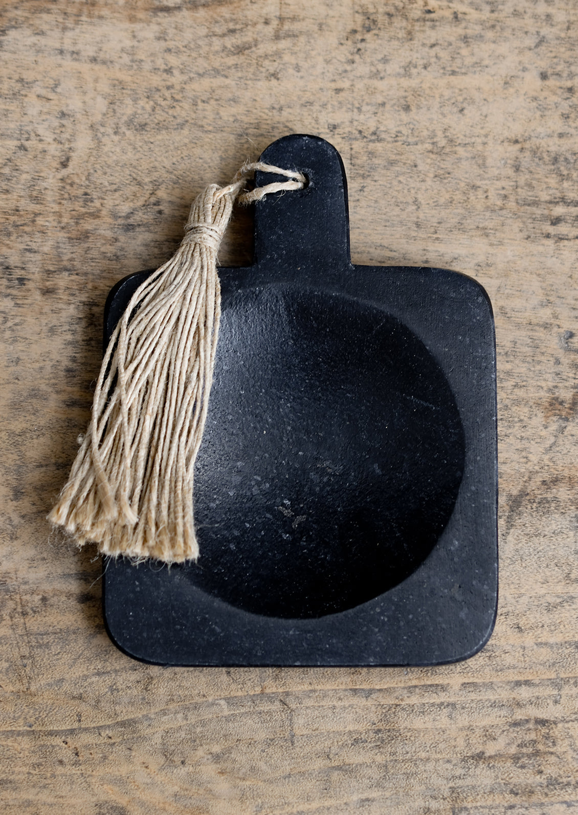 A paddle shaped marble spoon rest in black.
