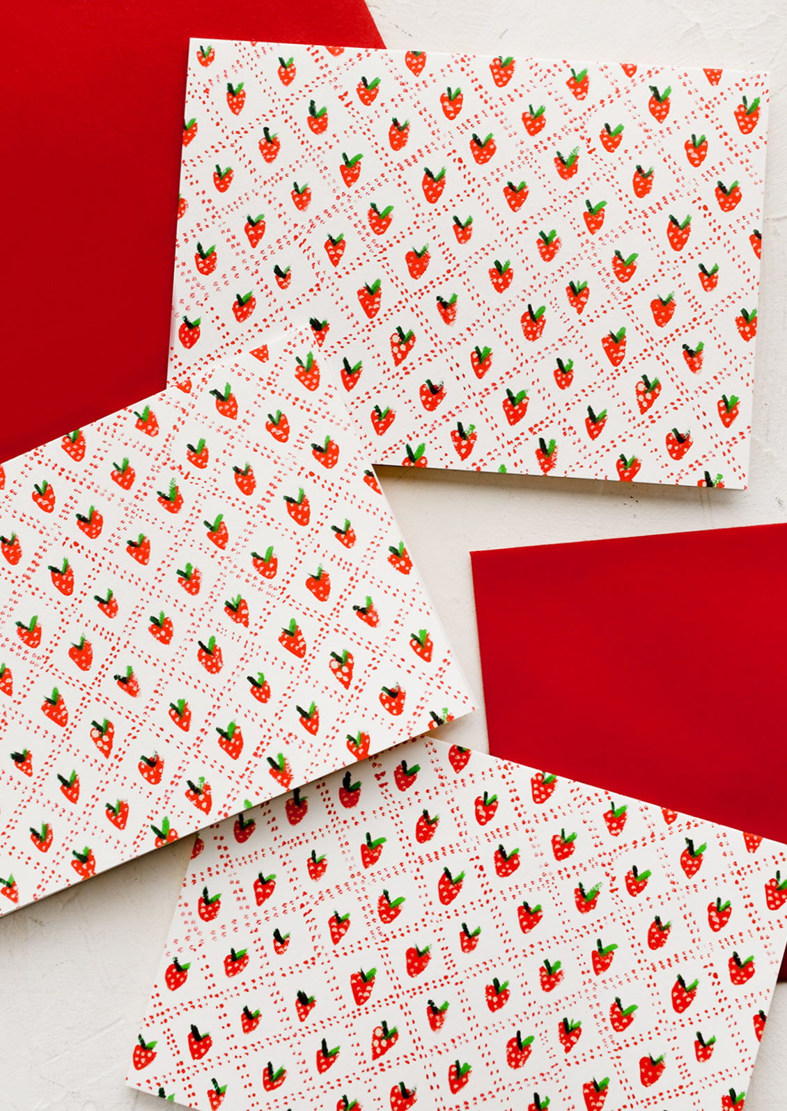 A boxed card set with quilted strawberry print.