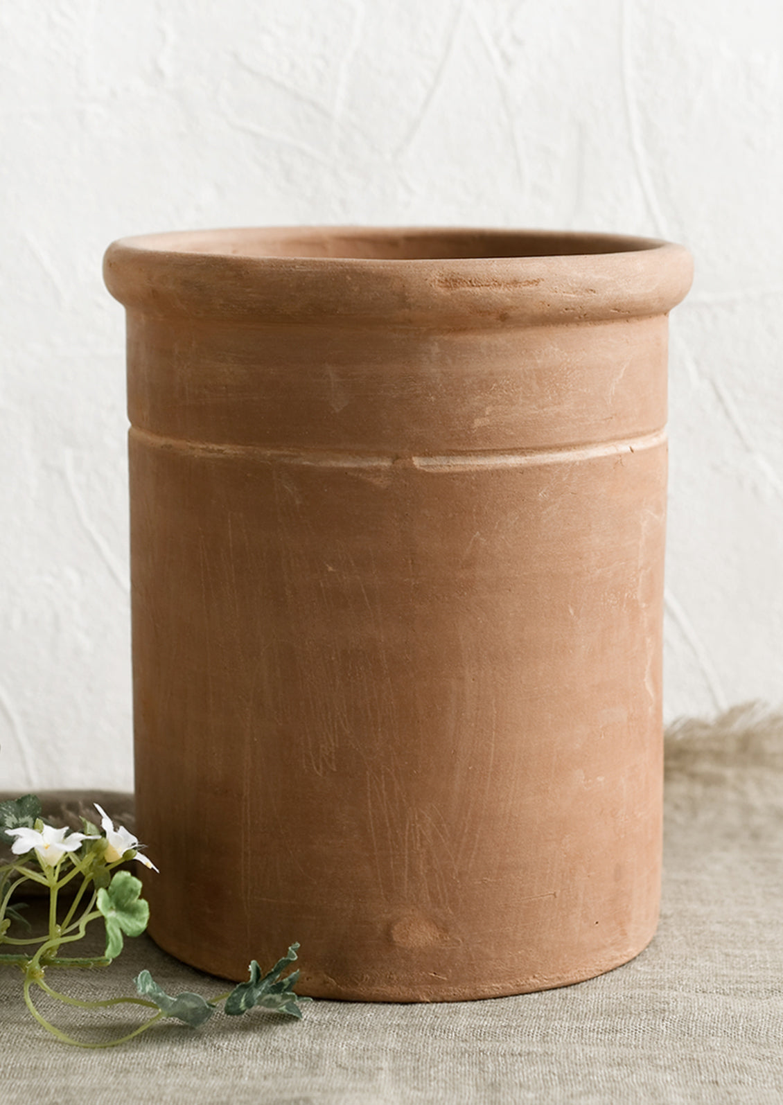 A large utensil crock in terracotta clay.