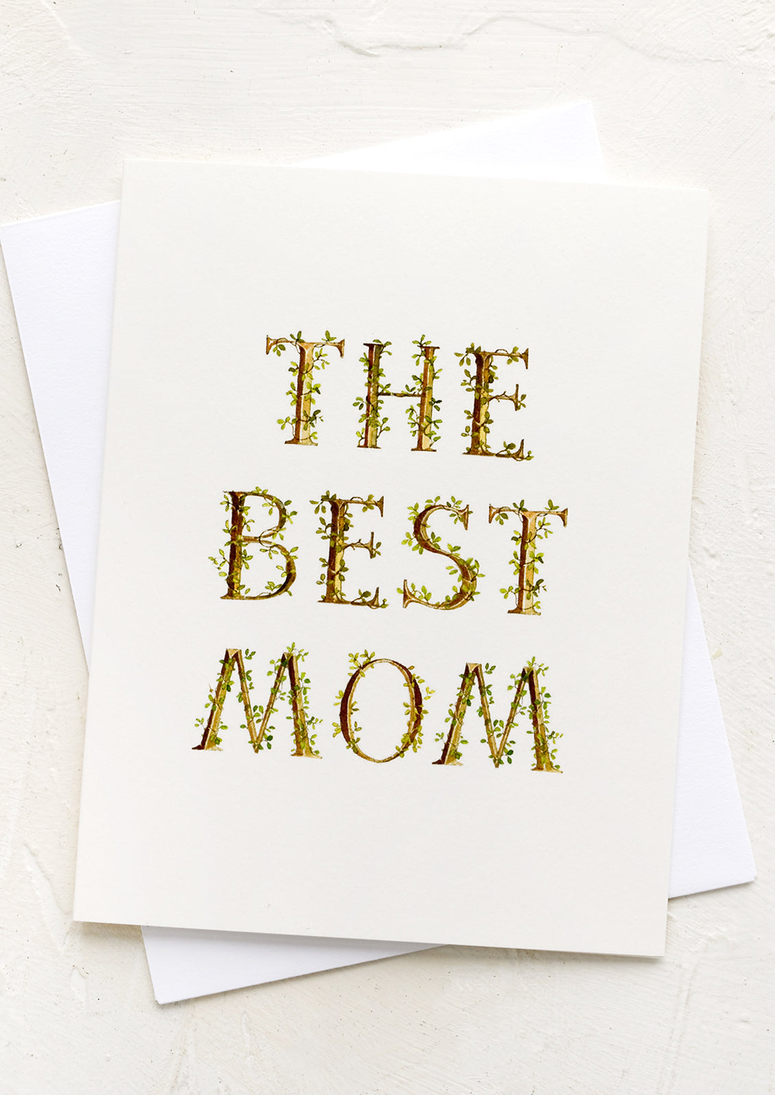 A card with leafy lettering reading "The Best Mom".